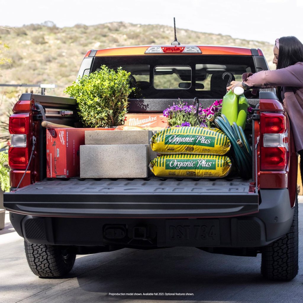 Person using their Maverick to haul gardening supplies