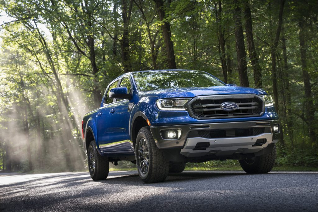 Blue Ford Ranger Driving in Forest During Spring