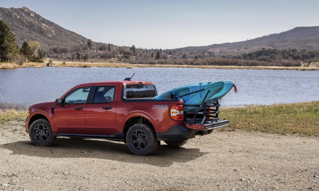 Ford Maverick hauling kayaks lakeside