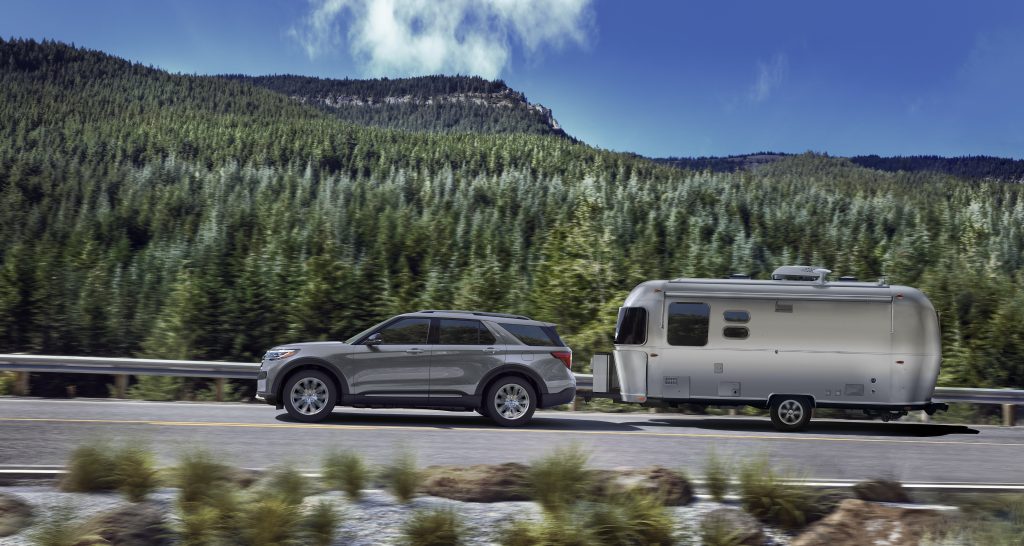 Ford Explorer towing camper on road-trip