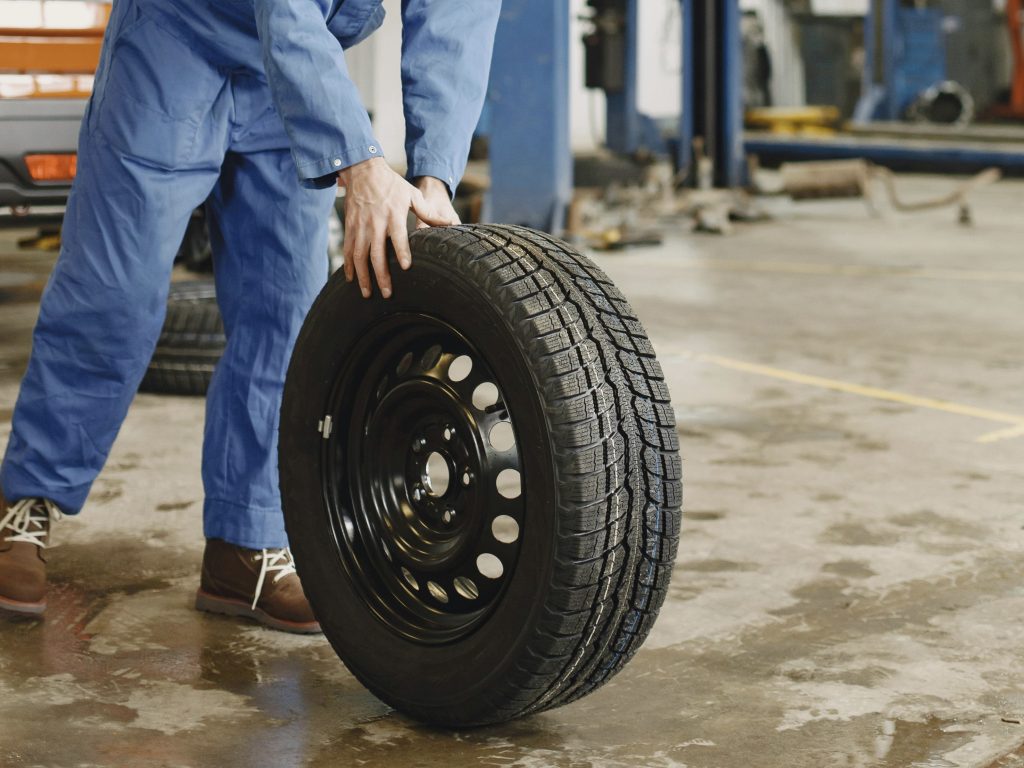 technician performing tire rotation