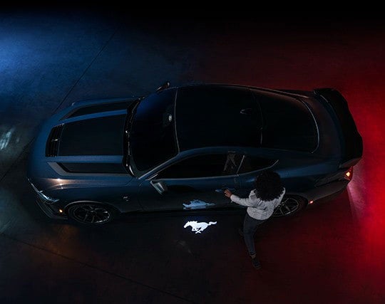 2024 Ford Mustang® Dark Horse™ model with a driver approaching the vehicle | White's Canyon Ford in Spearfish SD