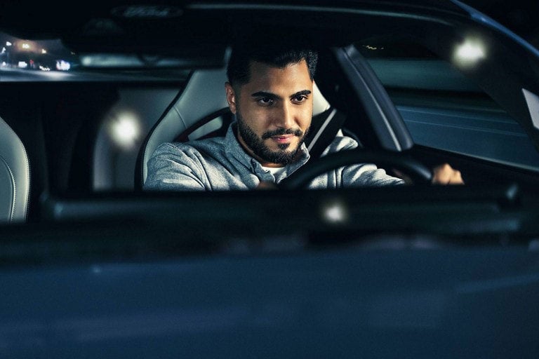 Person sitting in the driver’s seat of a parked 2024 Ford Mustang® coupe | White's Canyon Ford in Spearfish SD
