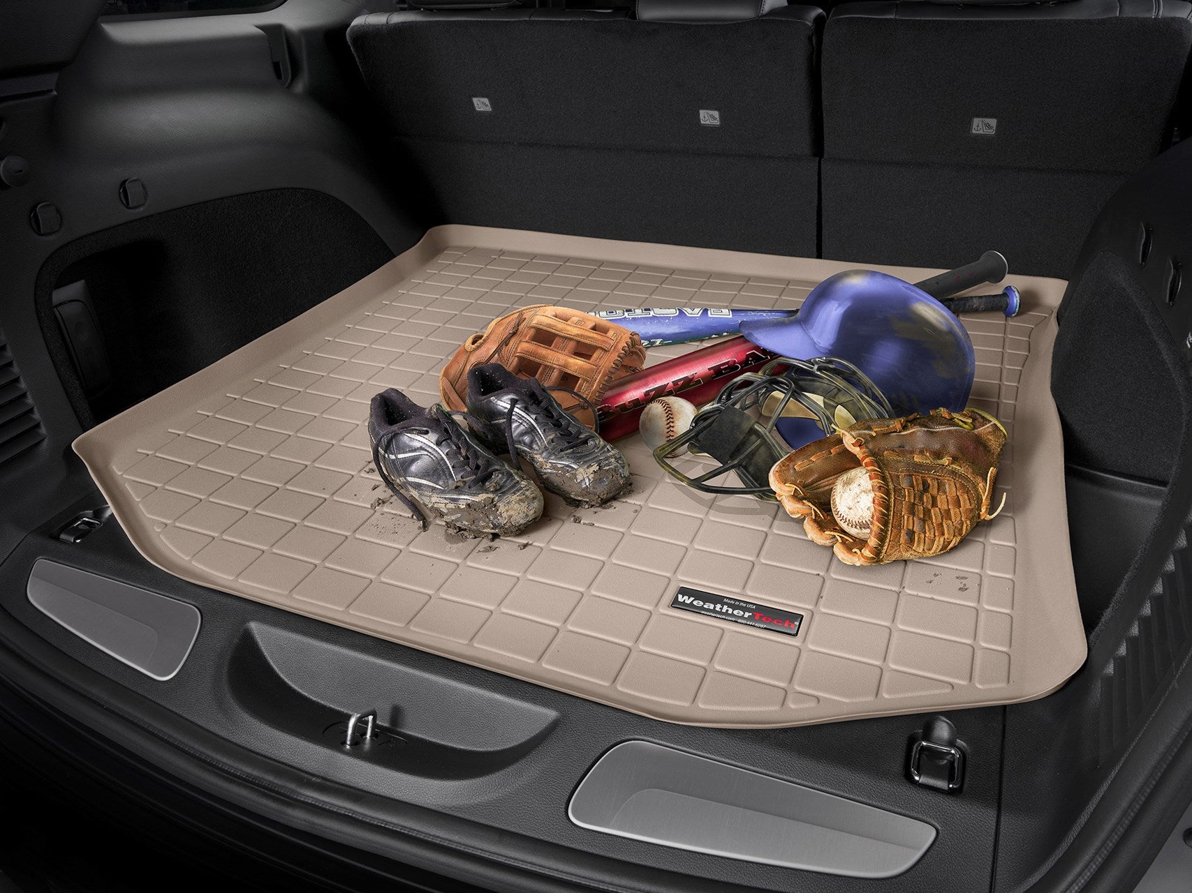 Brown WeatherTech trunk liner with baseball equipment on top