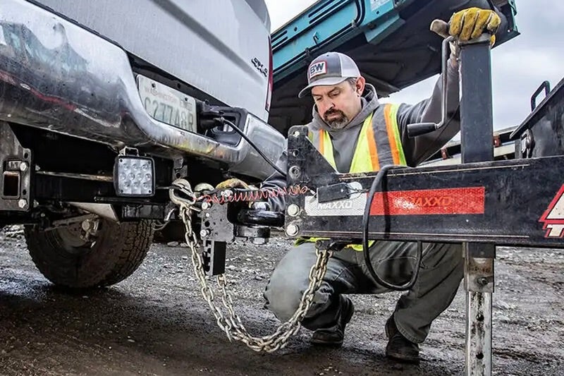 Man checking the Heavy Duty Receiver is properly attached to this truck
