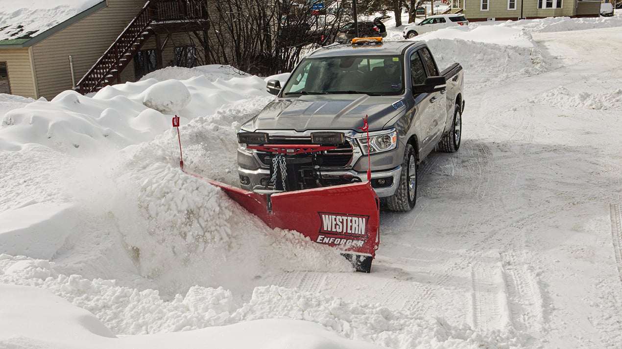Silver truck with a Western ENFORCER Snow Plow attached