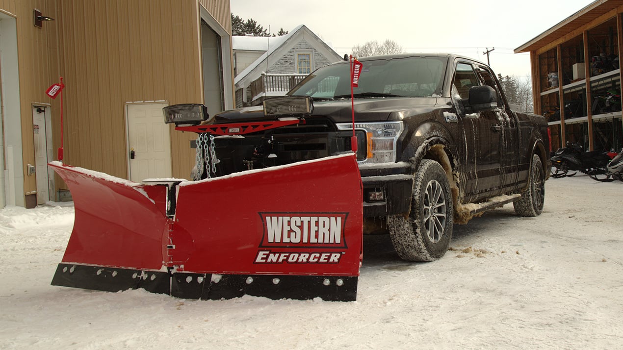 Black truck with a Western ENFORCER Snow Plow attached