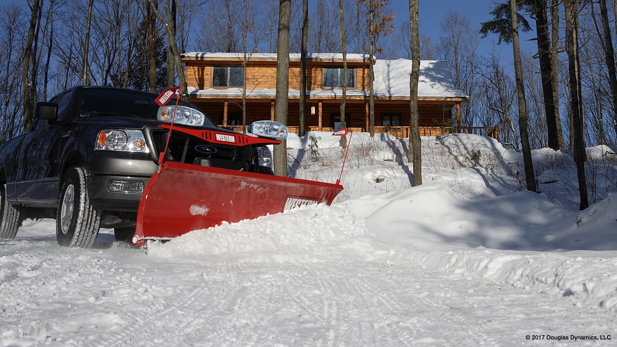 Side profile of a black truck with a Western HTS Snow Plow attached