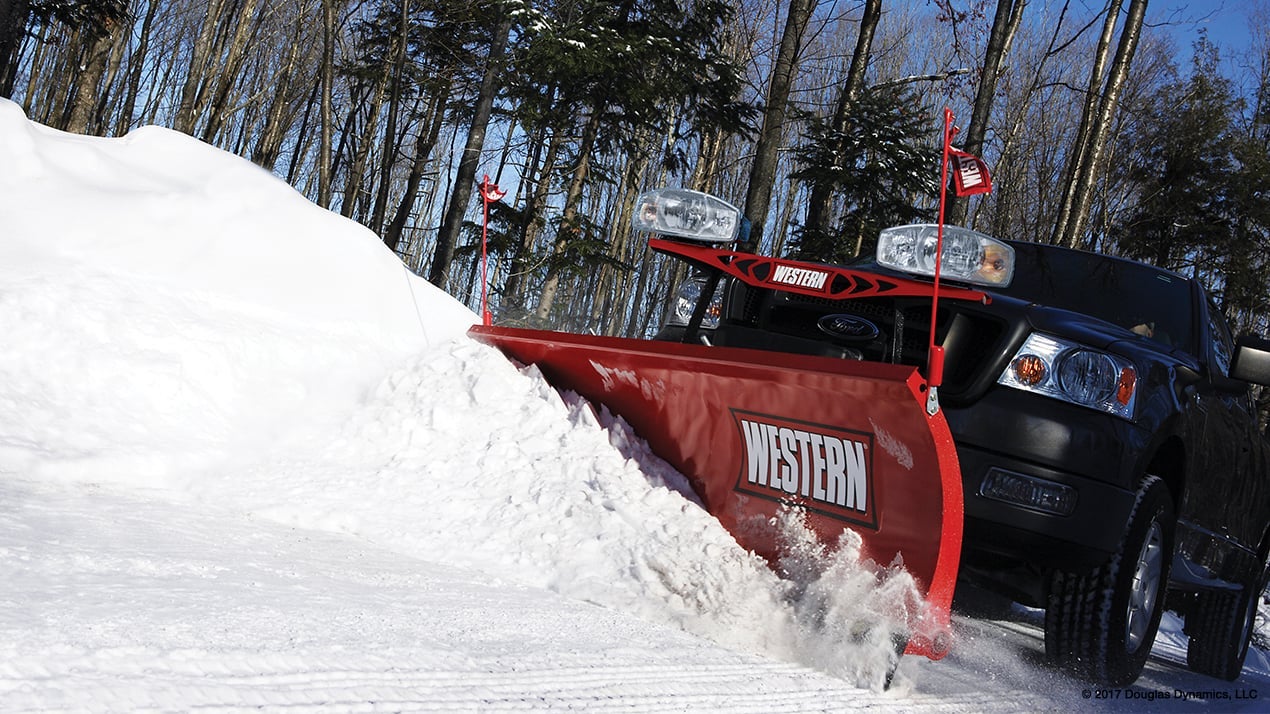 Front profile of a black truck with a Western HTS Snow Plow attached