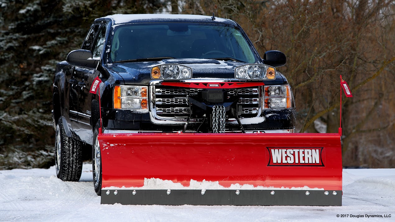 Front profile of a black truck with a Western MIDWEIGHT Snow Plow attached
