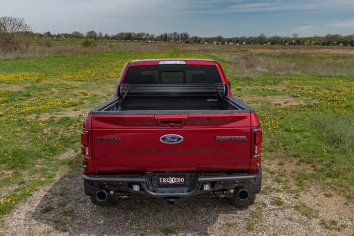 Sentry hard roll-up style truck bed cover on a red truck