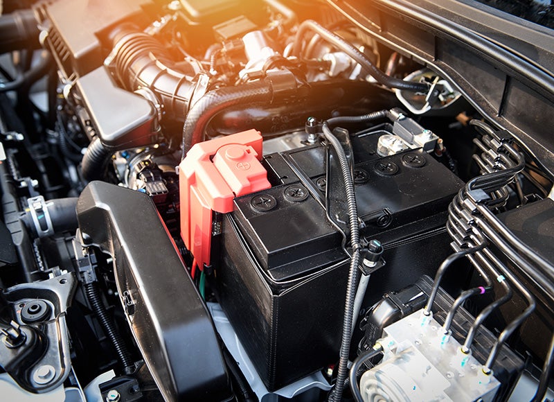 Technicians reviewing information beside a vehicle.