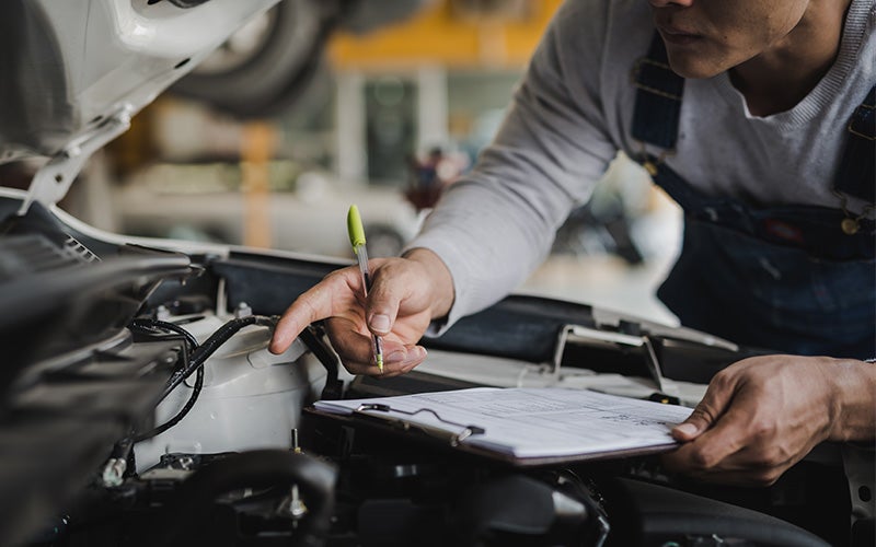 Technician performing a transmission inspection.