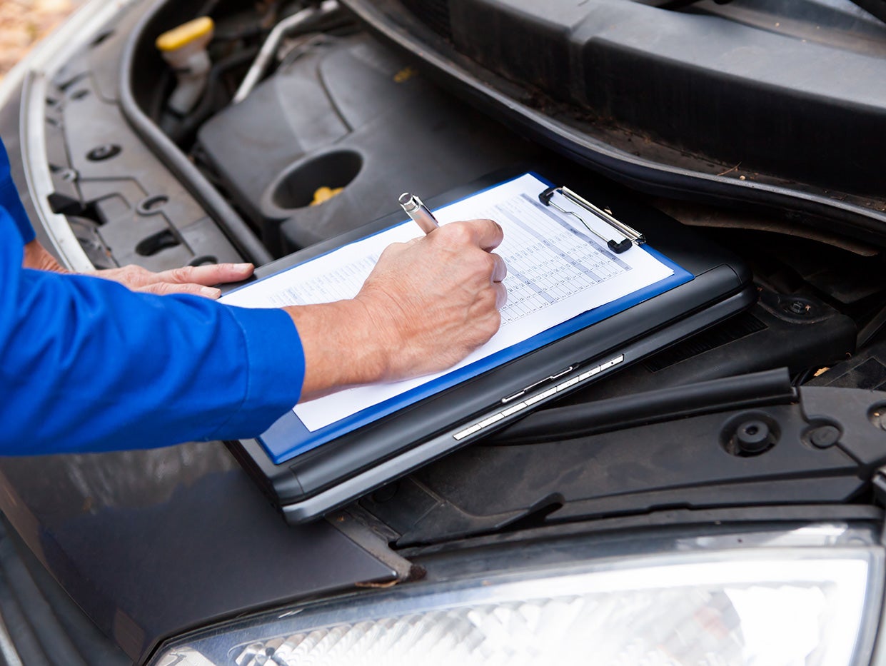 Technician performing a transmission inspection.